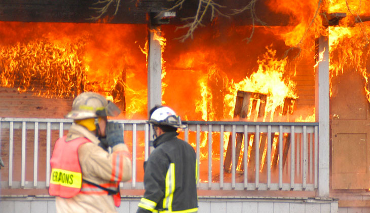 Fire fighters outside a house on fire