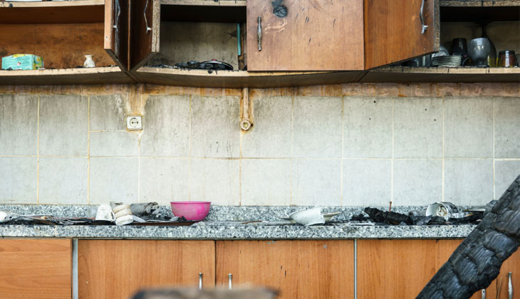 A kitchen damaged by smoke and fire